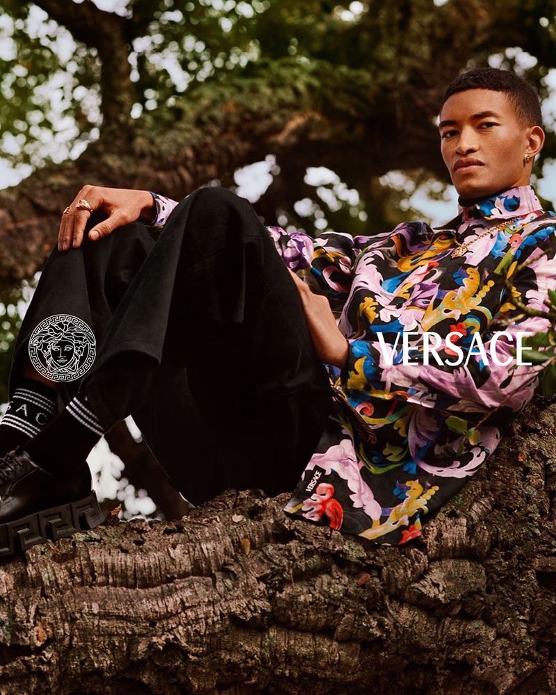 Donning a multicolored top and oversized pants, Raphael Balzer fronts Versace's pre-fall 2021 men's campaign.