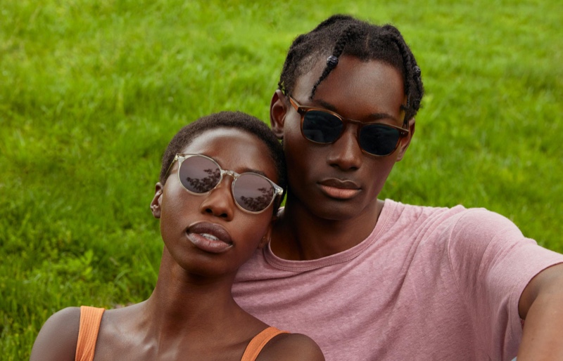 Relaxing on a cool day, Youssouf Bamba wears Warby Parker's Elio sunglasses in Black Walnut.