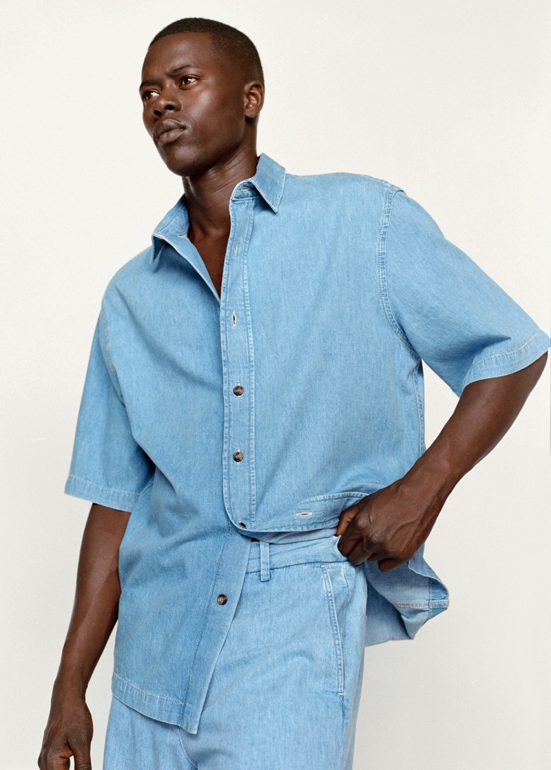 Doubling down on denim, Alpha Dia wears an oversized short-sleeve denim shirt with jeans from Mango.