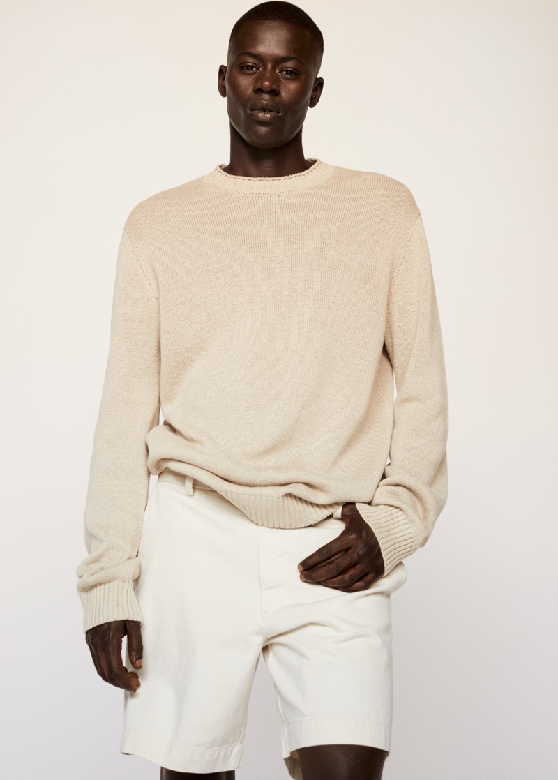 Embracing neutrals, Alpha Dia wears a knit sweater with shorts from Mango.