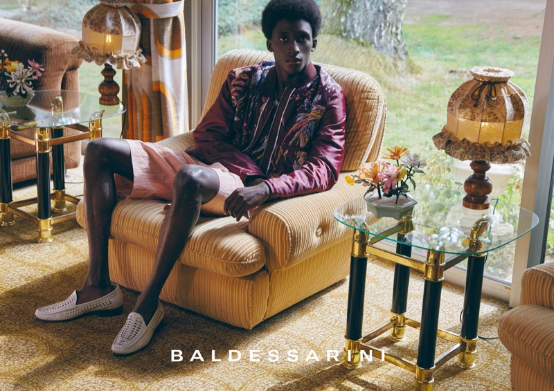 Embracing wine-colored hues, Amadou makes quite the fashion statement in Baldessarini's spring-summer 2022 campaign.