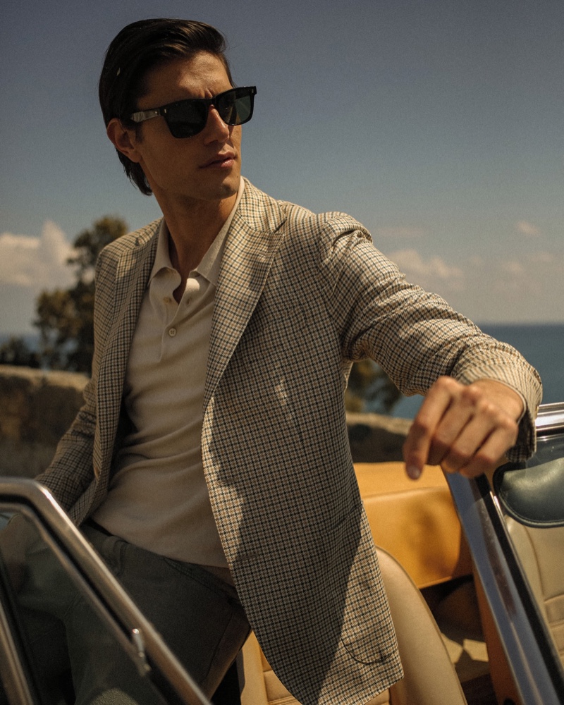 Modeling a checked jacket, Marco Castelli appears in Boglioli's summer 2021 campaign.