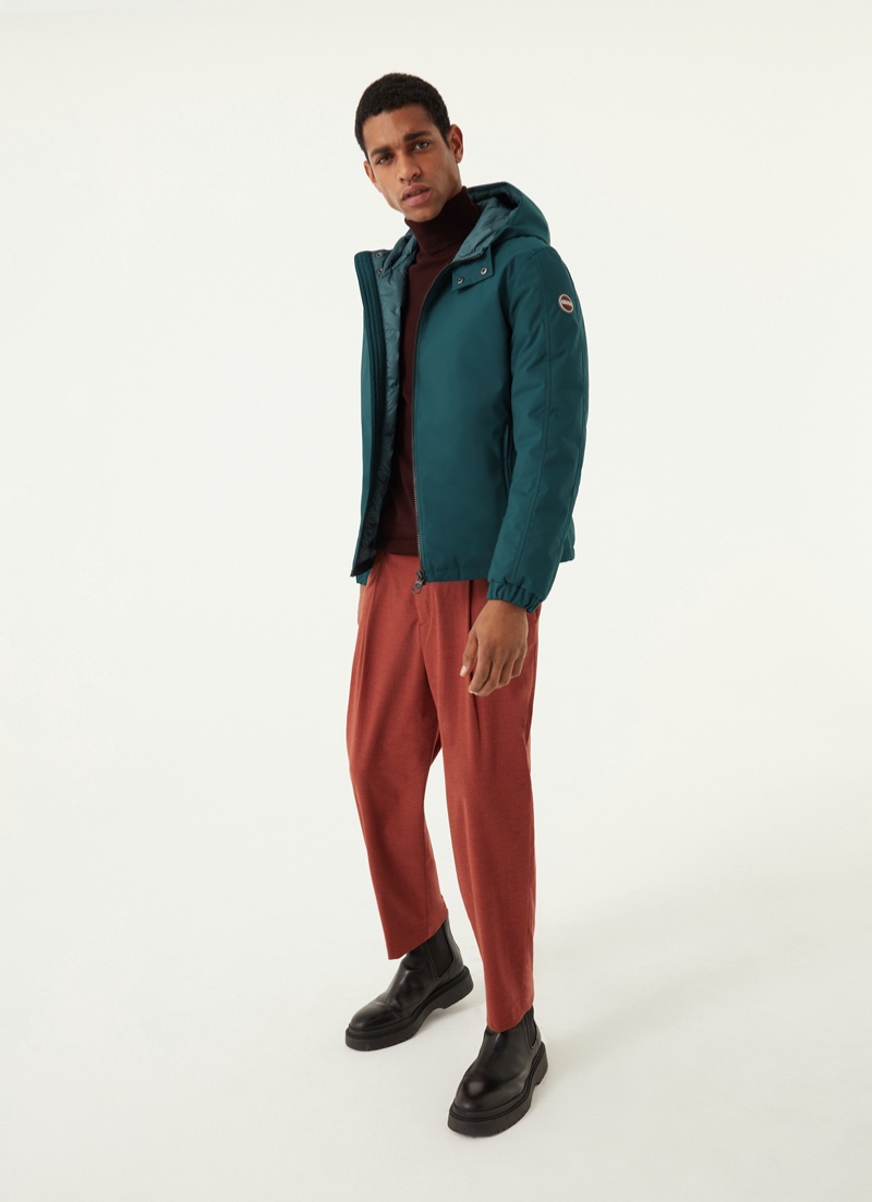 Angelo Gomez wears Colmar Originals' opaque stretch down jacket with hood in green.