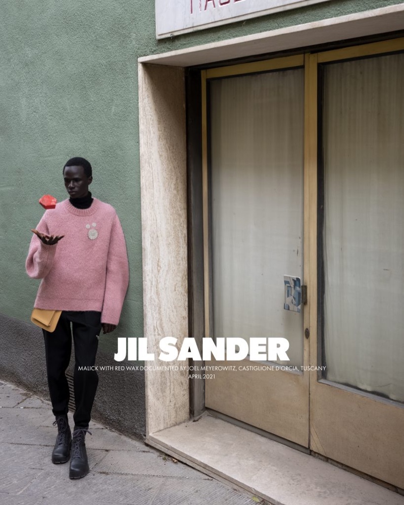 Exploring the streets of Buonconvento, Malick Bodian fronts Jil Sander's fall-winter 2021 men's campaign.