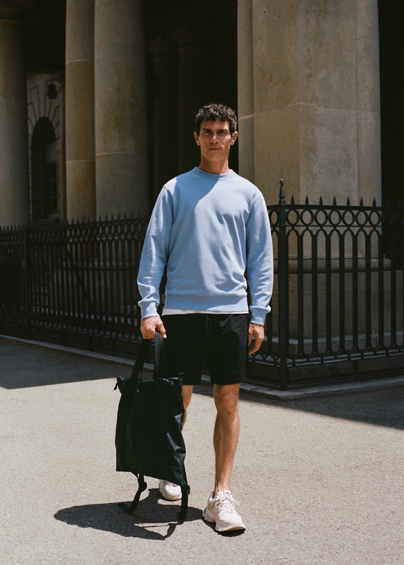 Stepping outside, Vincent Lacrocq models a sweatshirt with shorts from Mango Man's Leisure collection.