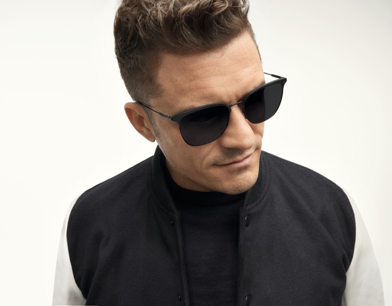 A cool, modern vision, Orlando Bloom rocks BOSS's lightweight sunglasses in matte black with gray lenses.