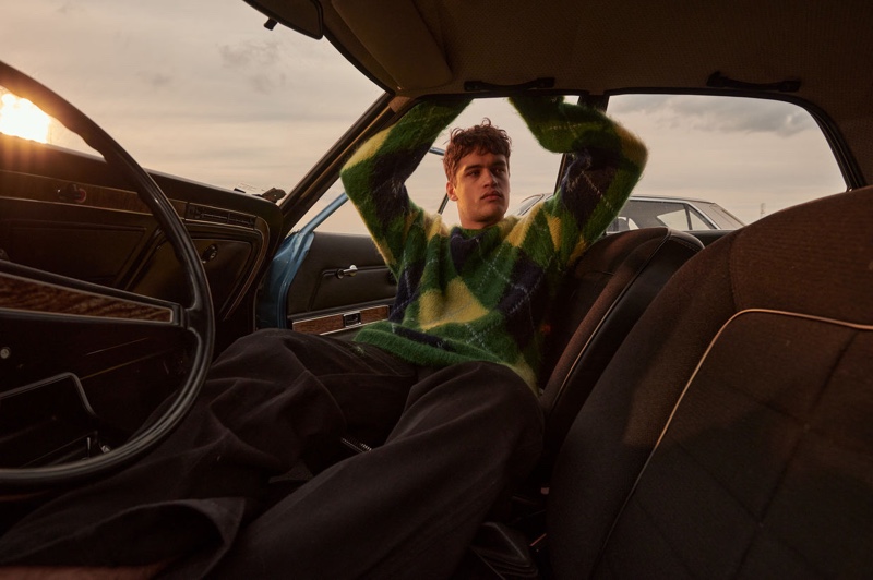 Roman G. wears an argyle sweater from Kenzo for Stylebop.