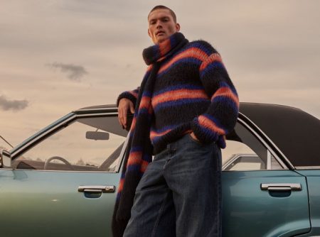 William Los models a matching striped sweater and scarf from Kenzo.