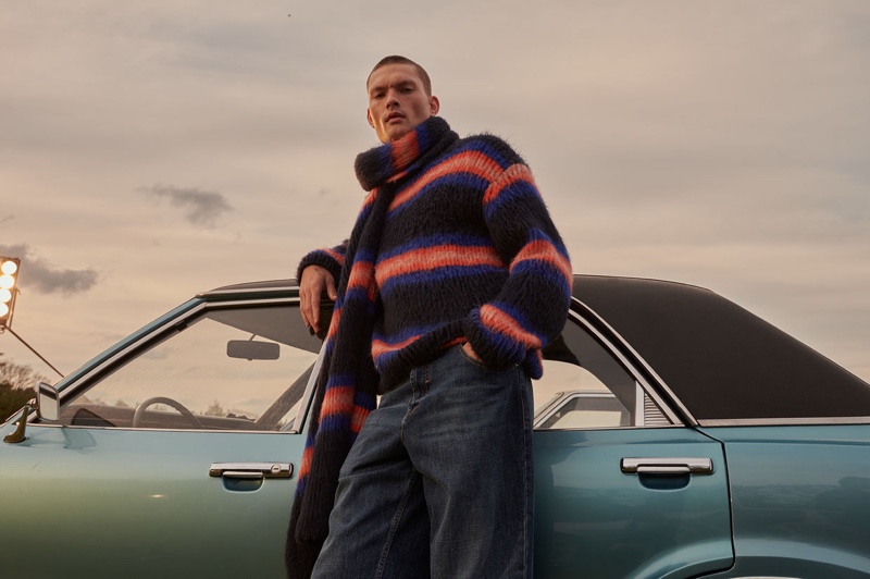 William Los models a matching striped sweater and scarf from Kenzo.