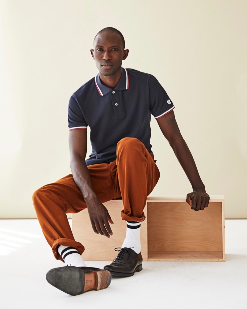 Embracing fall tones, Armando Cabral wears a Todd Snyder polo with relaxed pants.