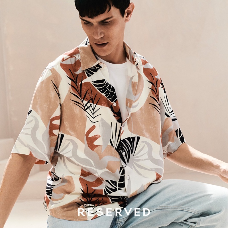 Vincent Lacrocq wears a graphic short-sleeve shirt with denim from Reserved.