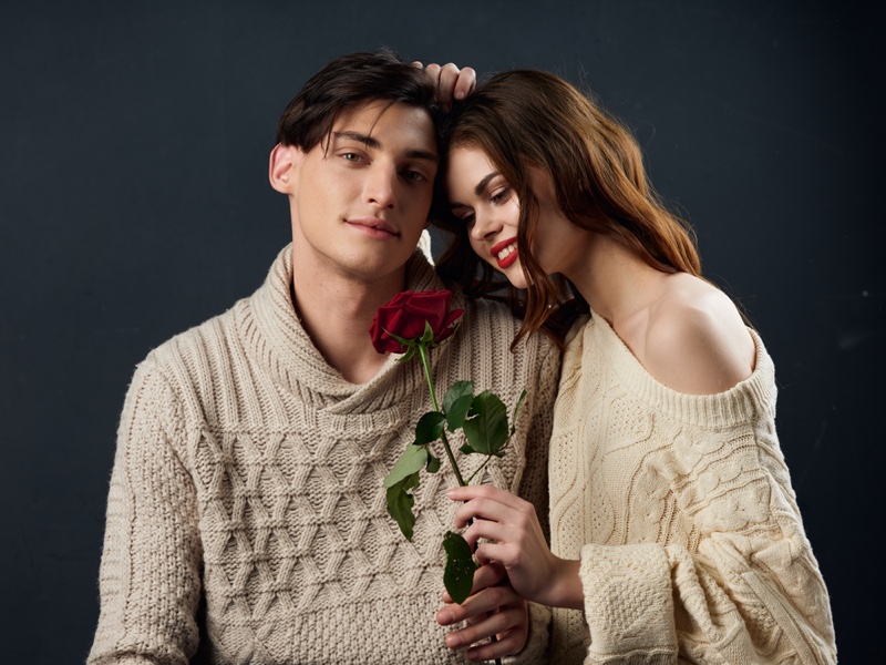 Young Couple Knit Sweaters Woman Holding Rose