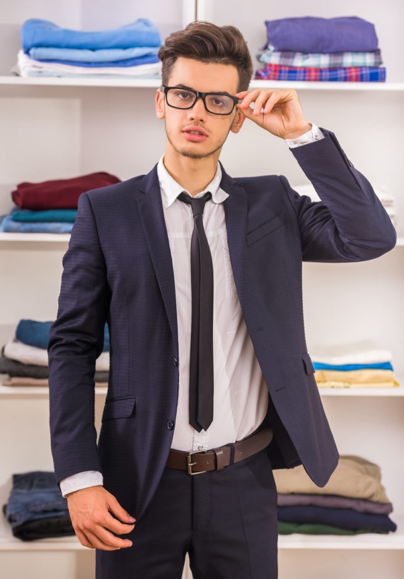 Young Man Wearing a Suit and Glasses