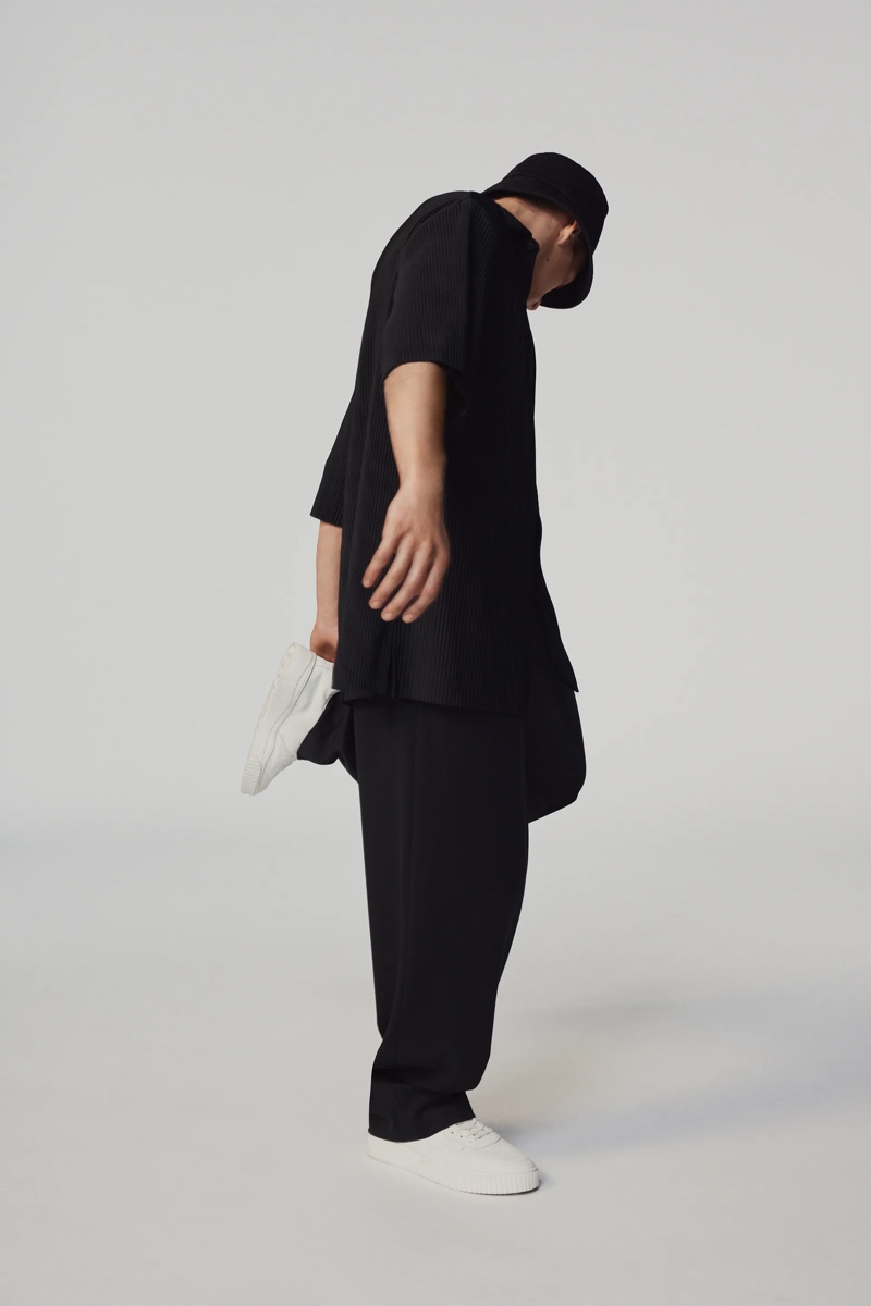 Embracing relaxed proportions, Andreas models a pleated oversized top and pants by Zara.
