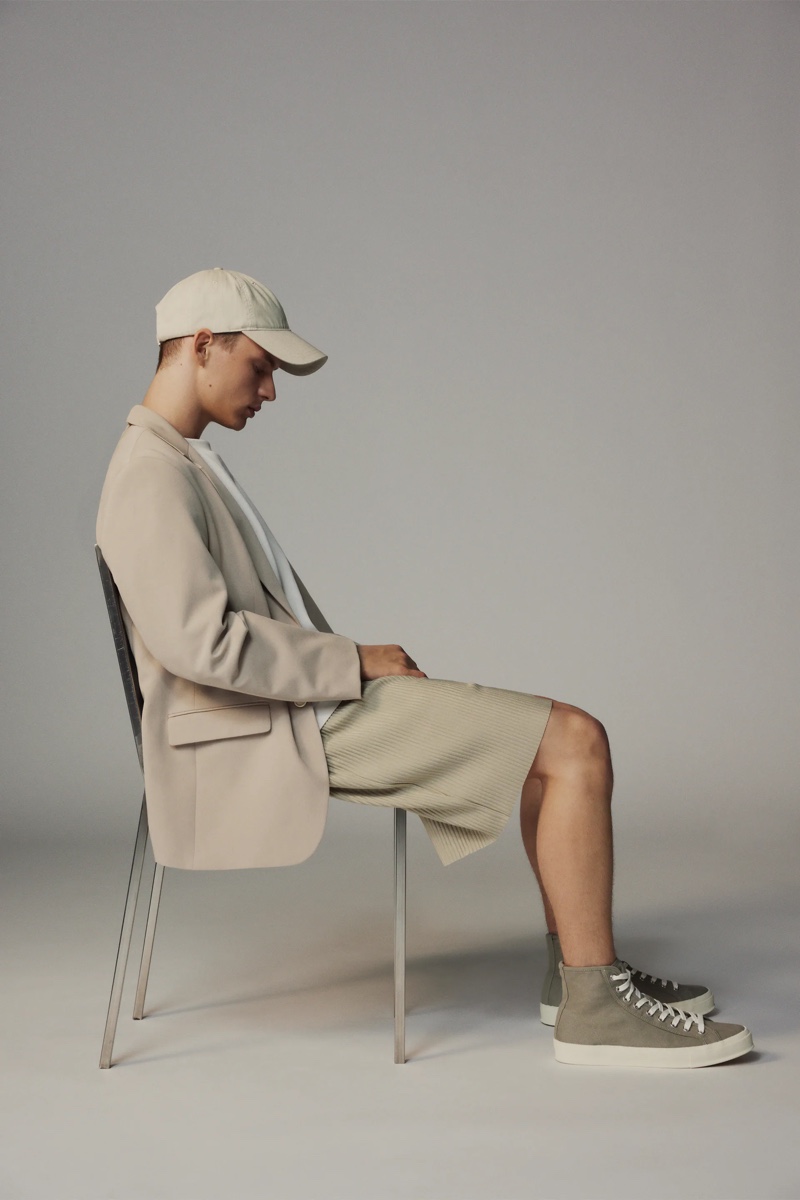 A sleek modern vision, Andreas models pleated oversized shorts with a blazer and cap by Zara.
