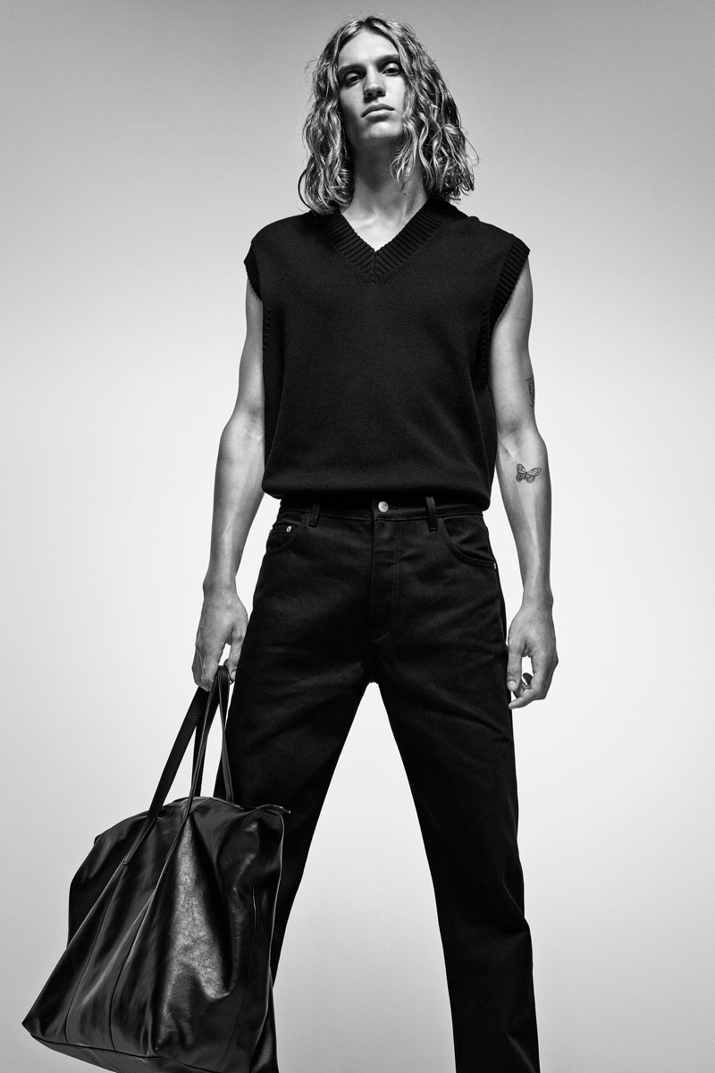 Making a style statement in black, Caleb Altice models Zara's knit v-neck vest.