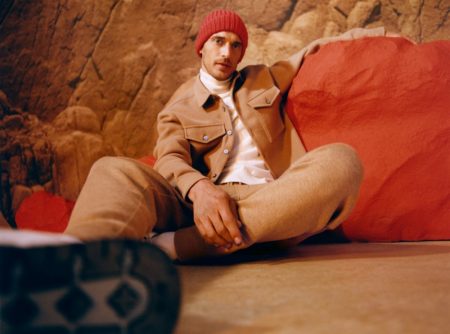 Clément Chabernaud dons a tan colored jacket and joggers with a turtleneck for BOSS's fall-winter 2021 men's campaign.