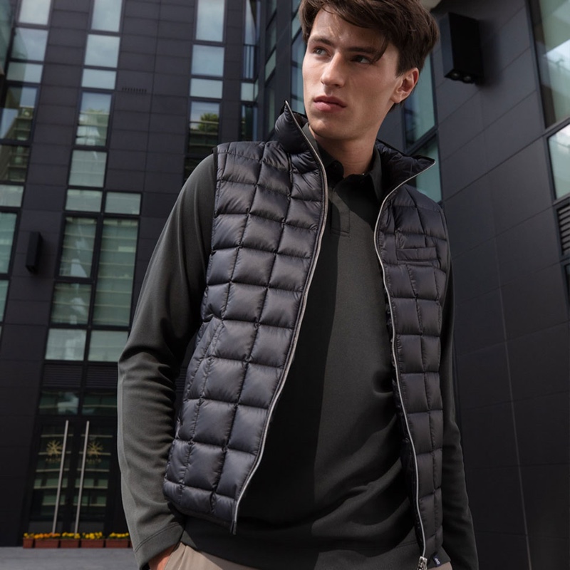 Clement Deheunynck wears a quilted vest over a long-sleeve polo from Boggi Milano.