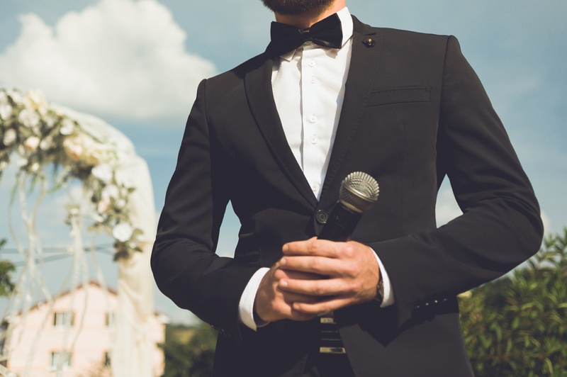 Cropped Groom Tuxedo Microphone Speech