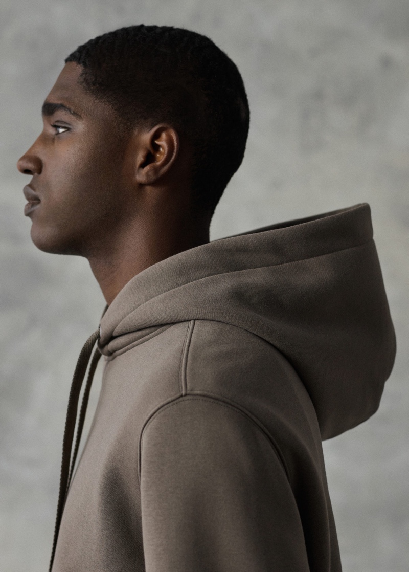 Delivering a side profile, Diogo Gomes sports a Mango hoodie cotton sweatshirt.