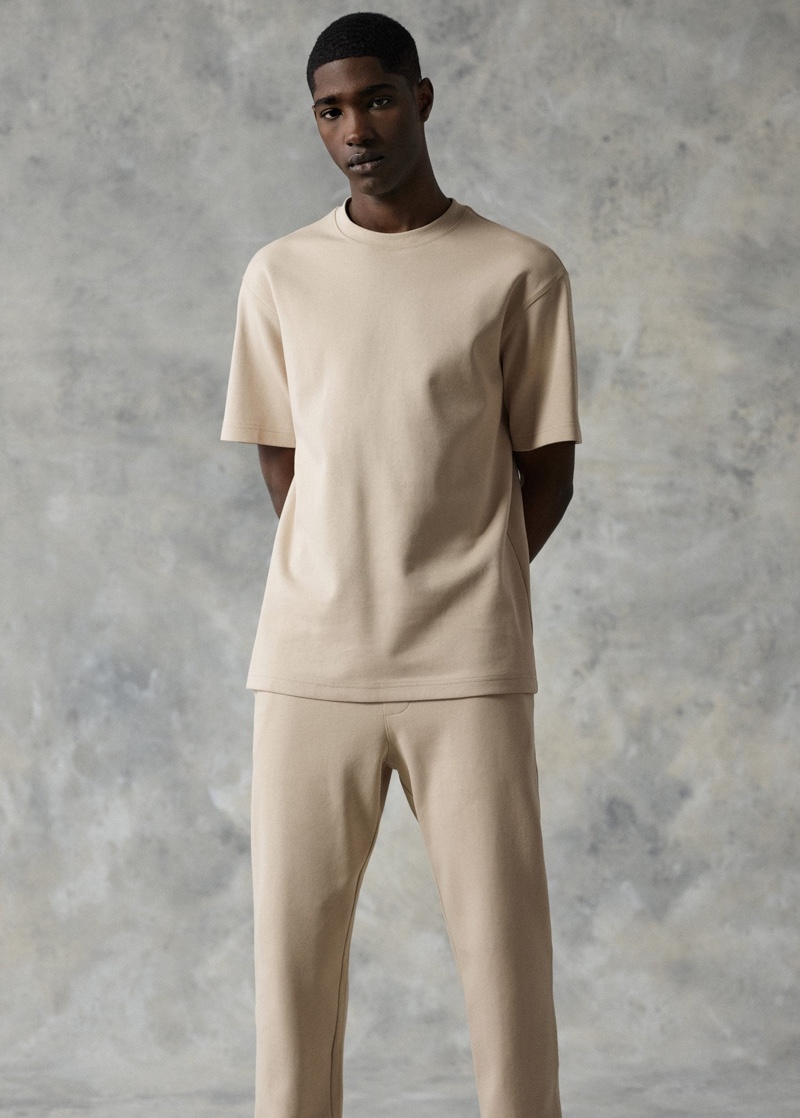 Front and center, Diogo Gomes sports a Mango plain cotton t-shirt with jogger-style trousers.