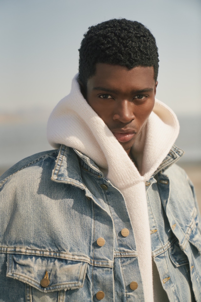 Alton Mason wears a denim jacket with a knit hoodie for Fear of God's fall-winter 2021 campaign.