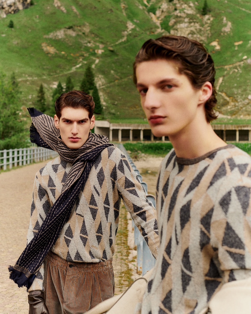 Models Emiliano Marku and Hugo Gillain sport geometric print sweaters from Giorgio Armani. 