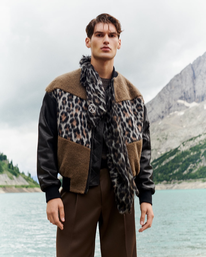 Emiliano Marku makes a bold statement in a leopard print bomber jacket with a matching scarf from Giorgio Armani.