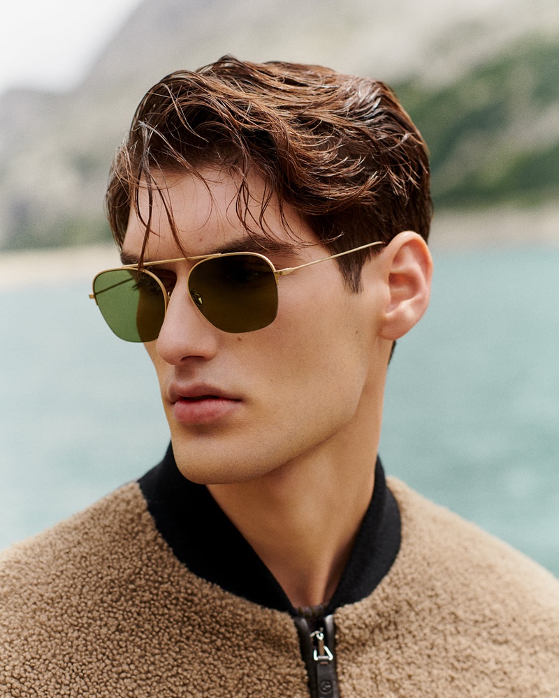 Ready for his close-up, Emiliano Marku rocks gold-framed aviator sunglasses from Giorgio Armani.