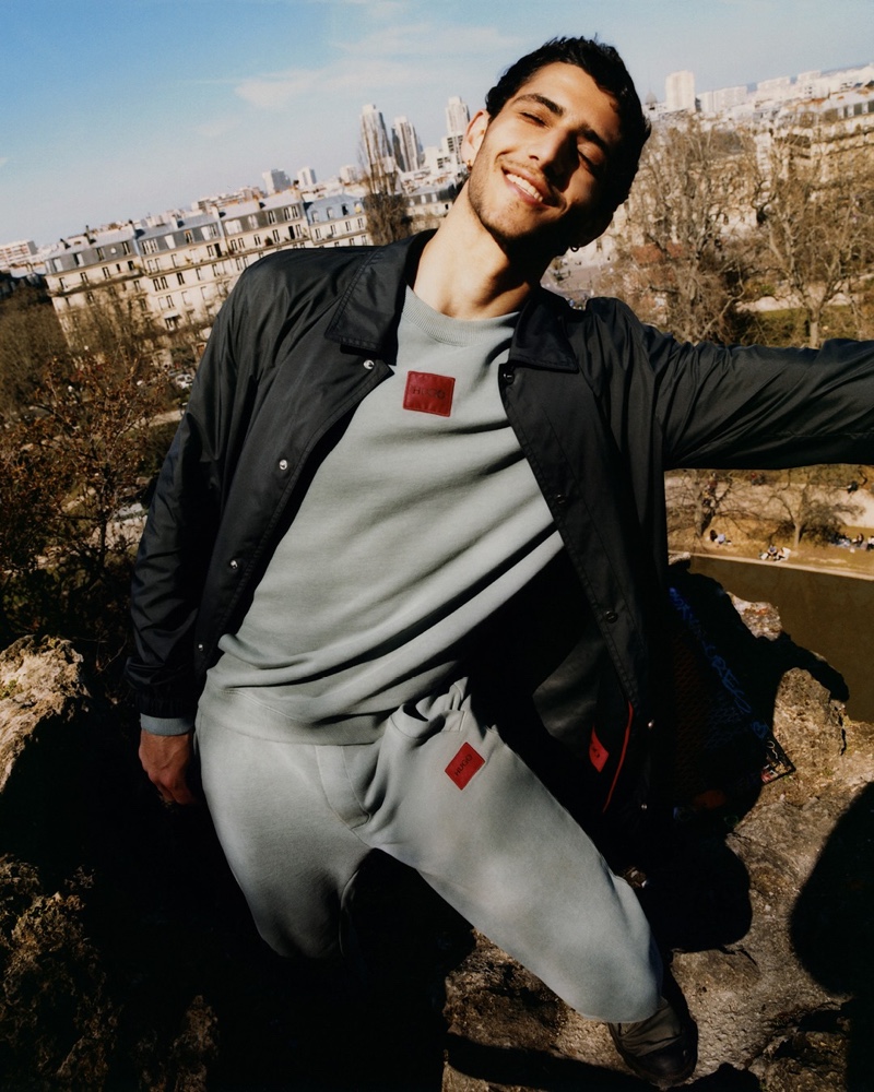 Going casual in a matching sweatshirt and joggers, Ahmad Kontar appears in HUGO's fall-winter 2021 men's campaign.