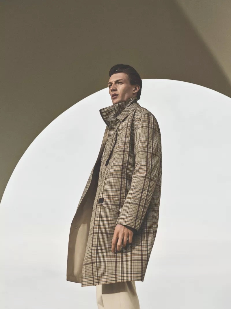 Model Finnlay Davis dons a tan plaid coat for Hermès' fall-winter 2021 men's campaign.