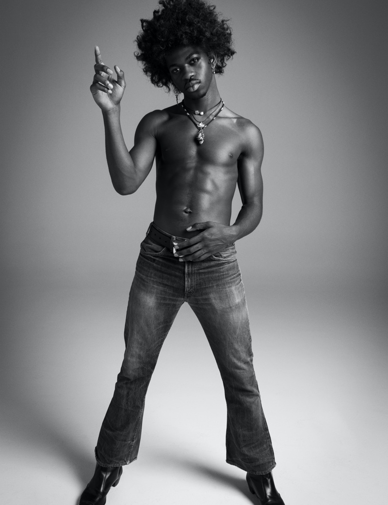 Going shirtless, Lil Nas X slips into a pair of vintage jeans as he channels Jimi Hendrix for VMAN.