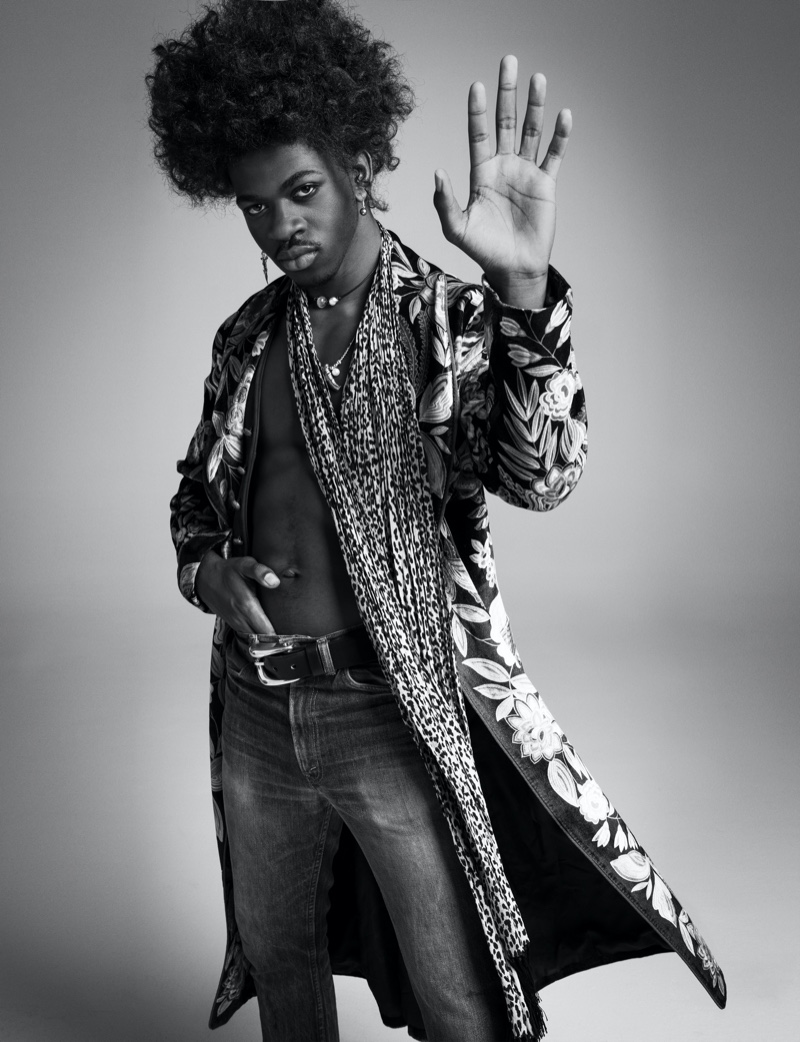 Singer Lil Nas X wears an Etro coat with vintage fashions and accessories for VMAN. 