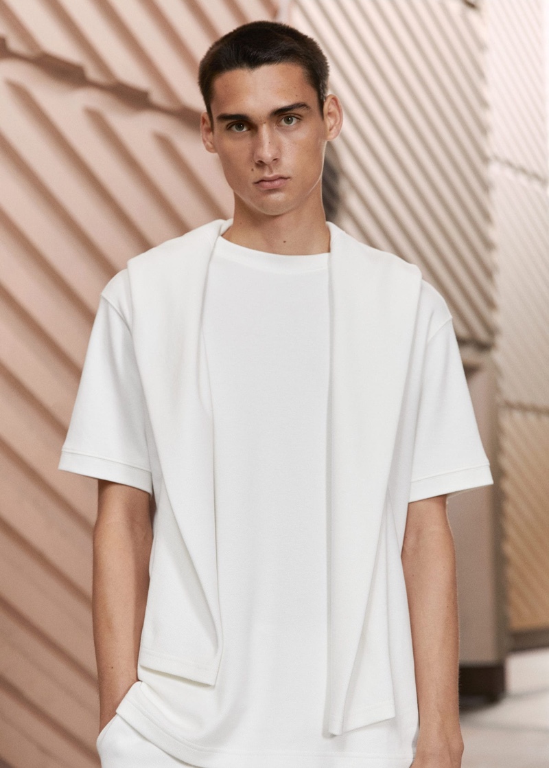 Ludwig Wilsdorff wears a Mango Man structured relaxed-fit t-shirt with a cotton sweatshirt draped over his shoulders.