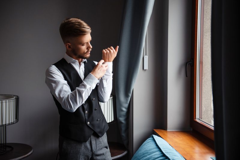 Man Putting on Cufflinks Man Putting on Cufflinks