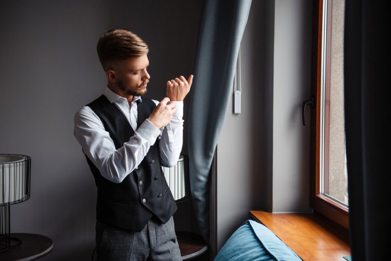 Man Putting on Cufflinks