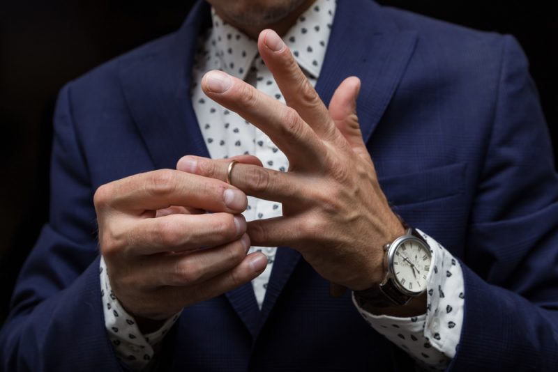 Man Putting on Wedding Band