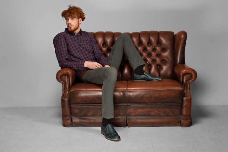 Man Sitting on Vintage Leather Couch