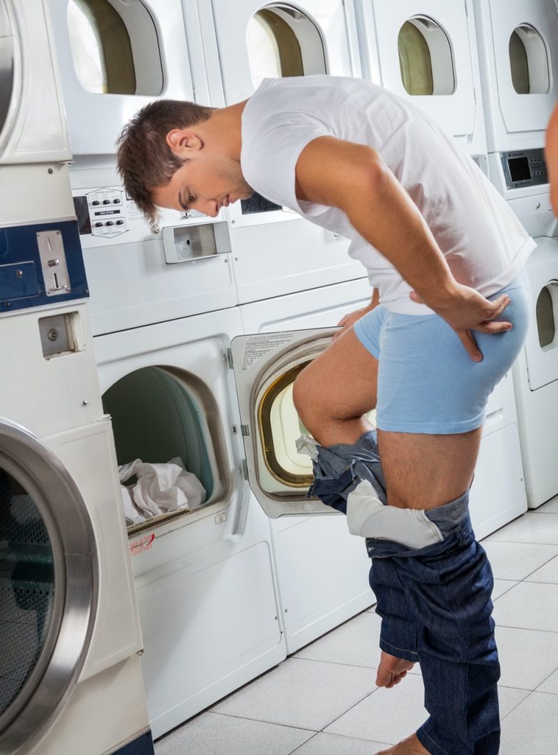 Man Taking Off Jeans to Wash Them