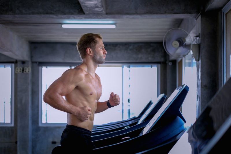 Man Working Out Running on Treadmill Shirtless
