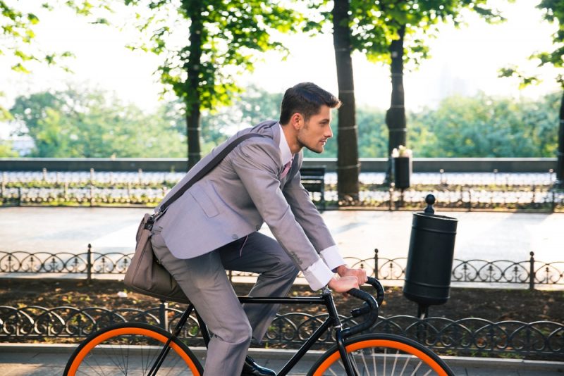 Man in Suit Riding Bike