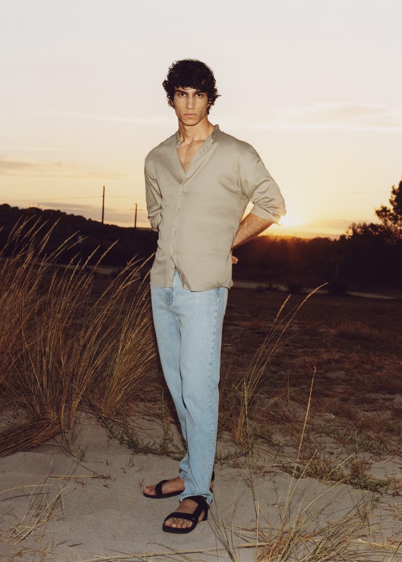 Front and center, Duncan Yair wears Mango's straight-fit light wash Bob jeans with a relaxed cotton mandarin collar shirt.