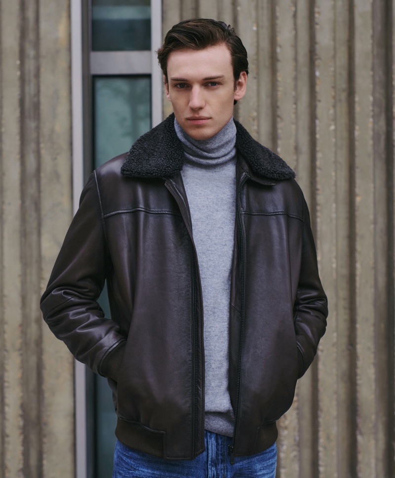 Jakob Zimny wears a leather bomber jacket with a turtleneck and jeans by Massimo Dutti.