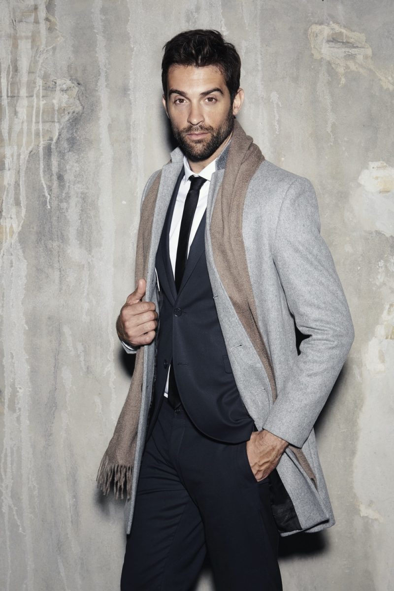 Model Wearing Suit and Coat Strong Posture