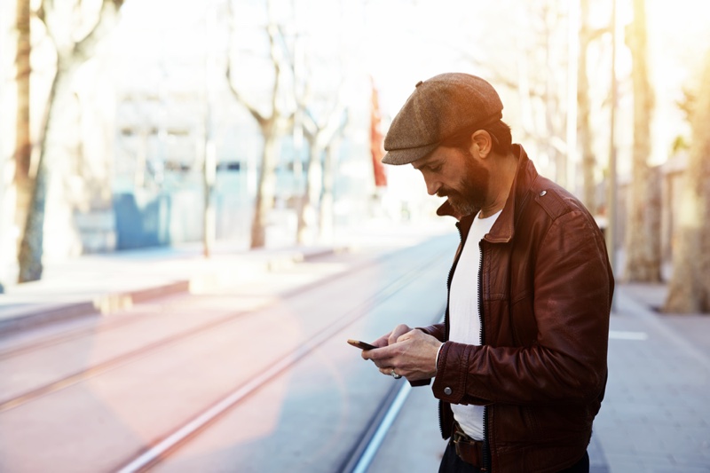 Stylish Man Using Phone Brown Leather Jacket Cap