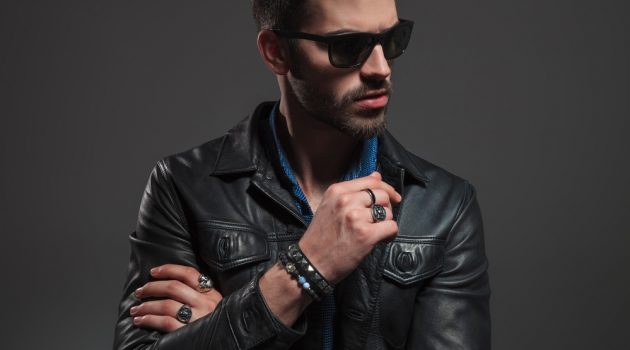 Everything You Need to Know About Wearing Rings Stylish Man in Leather Jacket Wearing Rings and Bracelets
