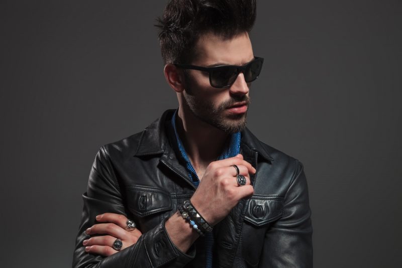 Stylish Man in Leather Jacket Wearing Rings and Bracelets