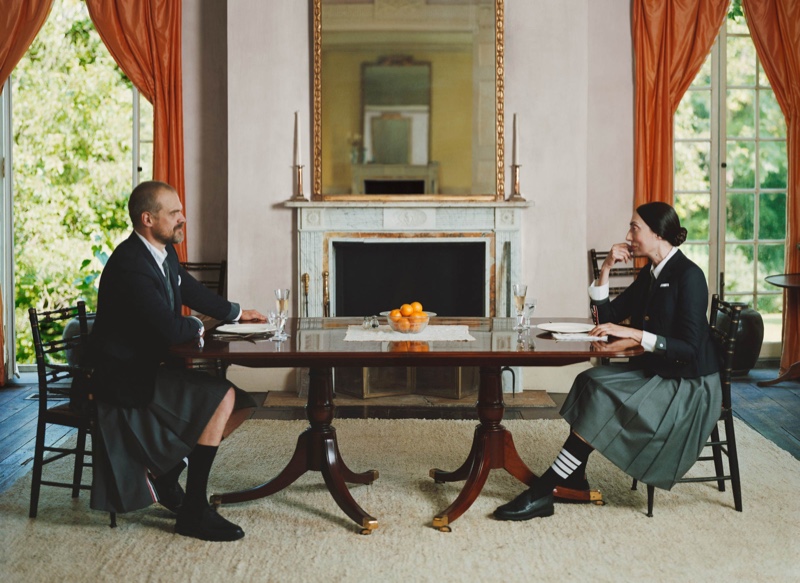 Sitting down for a meal, David Harbour and Anh Duong come together in fall 2021 fashions by Thom Browne.