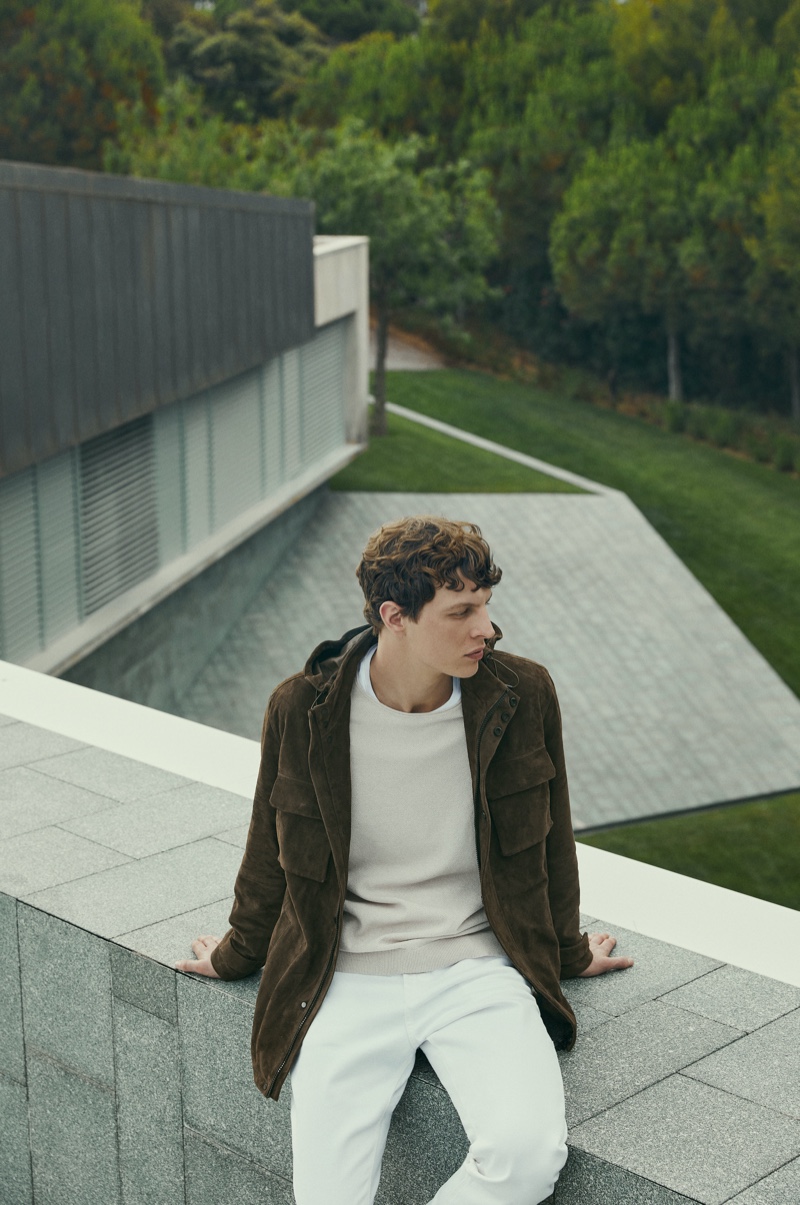 Massimo Dutti puts a neutral color palette on display as Tim Schuhmacher dons the brand's hooded suede jacket with a sweater and pants.