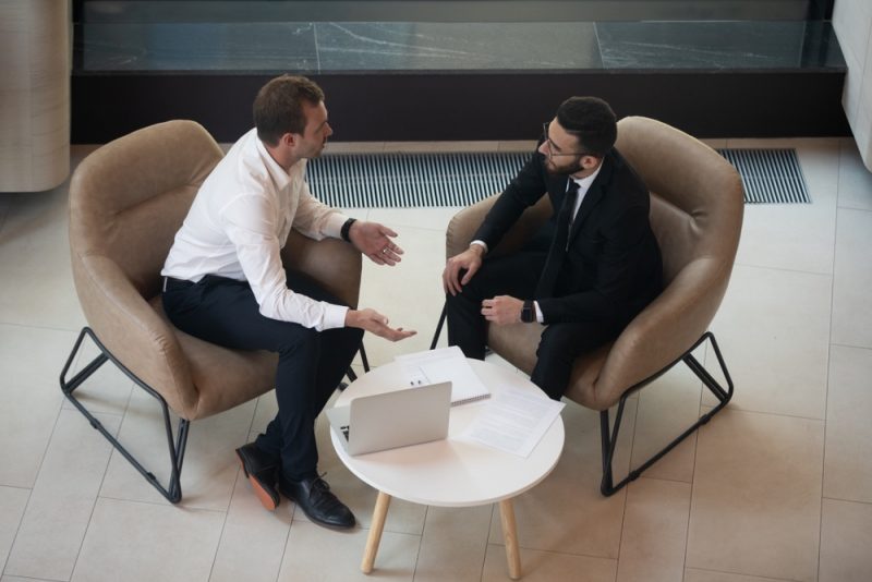 Two Men Talking Business Setting